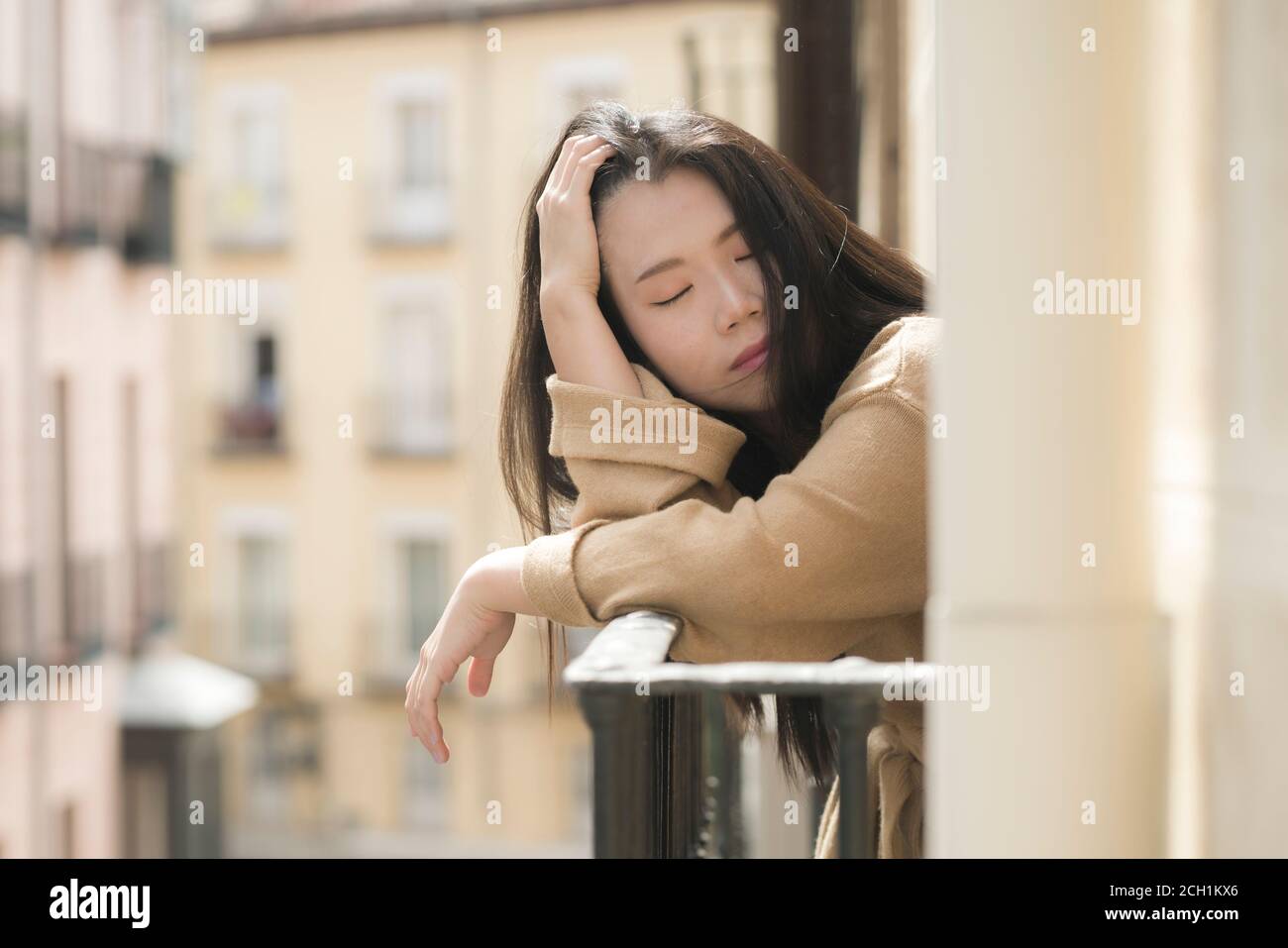 dramatic portrait of young beautiful sad and depressed Asian Japanese woman feeling unhappy and worried suffering some problem going through depressio Stock Photo