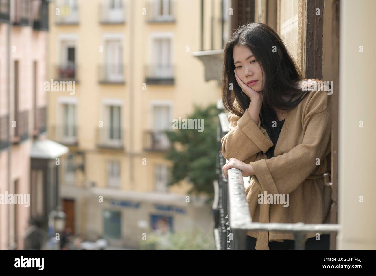 dramatic portrait of young beautiful sad and depressed Asian Japanese woman feeling unhappy and worried suffering some problem going through depressio Stock Photo