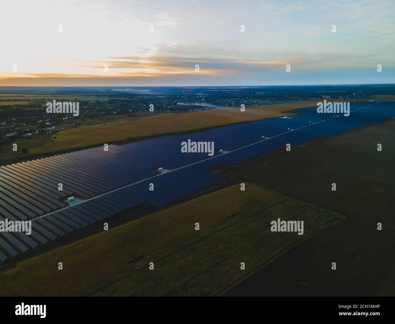 Aerial drone view into large solar panels at a solar farm in large ...