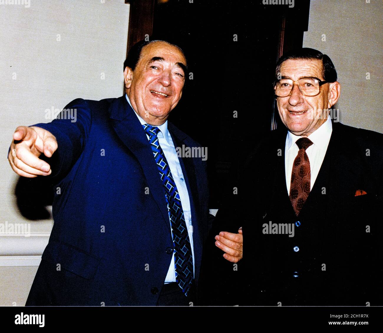 In this file photo from September 25, 1990, disgraced publisher Robert Maxwell, left, meets South African Ambassador to the United States Piet G.J. Koornhof in Washington, DC on September 25, 1990. The New York Post is reporting today that Maxwell, through his daughter Ghislaine Maxwell, may have been the source the huge fortune amassed by alleged pedophile Jeffrey Epstein, who hanged himself in his Manhattan lockup last August.Credit: Ron Sachs/CNP | usage worldwide Stock Photo