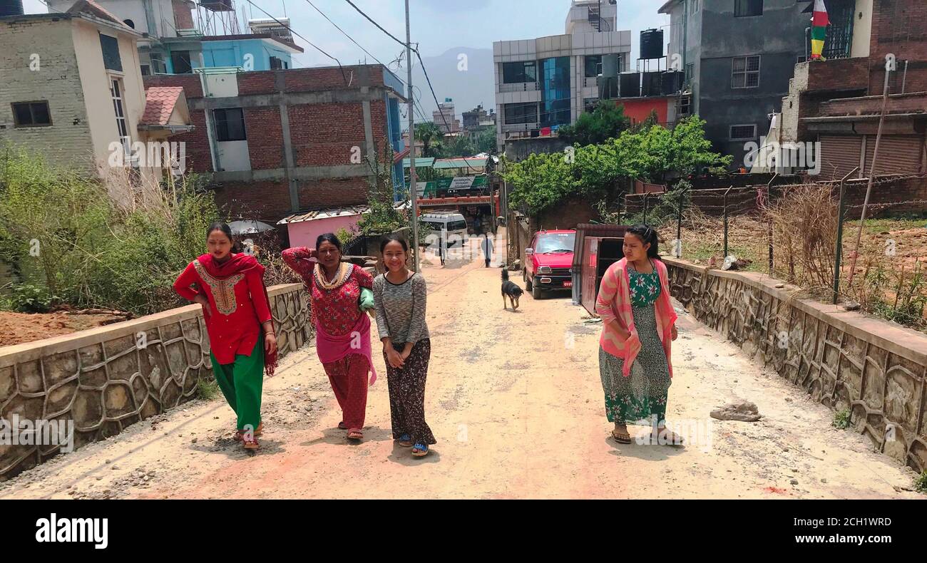 Nepali women and girl in national clothes of all ages walks the town street in Kathmandu, Nepal. Everyone has different appearance and character. Stock Photo