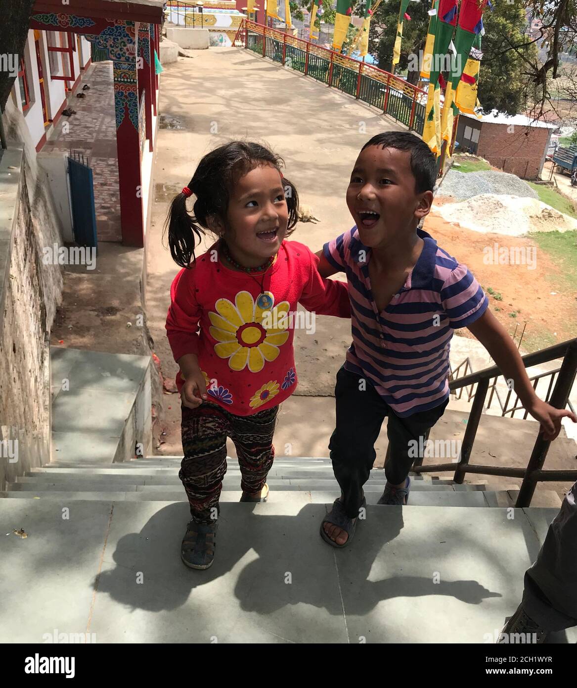 Cute smiling nepalese children. Laughing funny kids. Little friends, boy and girl from Kathmandu, Nepal. Happiness. Child smile. Glad nepali kids. Stock Photo