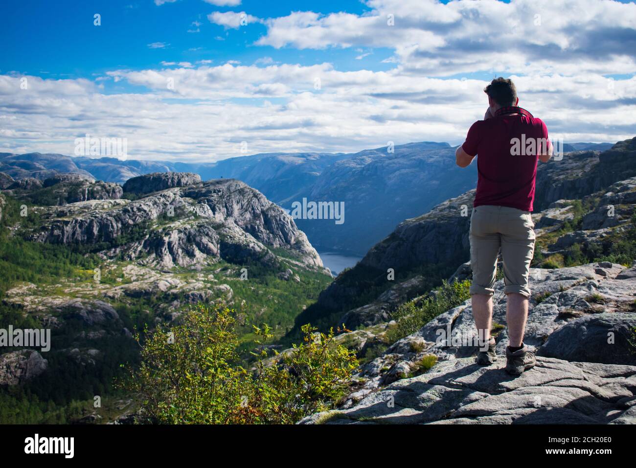 Tourist taking picture of fjord in route to preikestolen cliff in Stavanger  Norway Stock Photo - Alamy