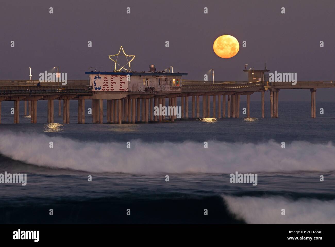 Full moon setting over Ocean Beach Pier, Ocean Beach, San Diego, California Stock Photo