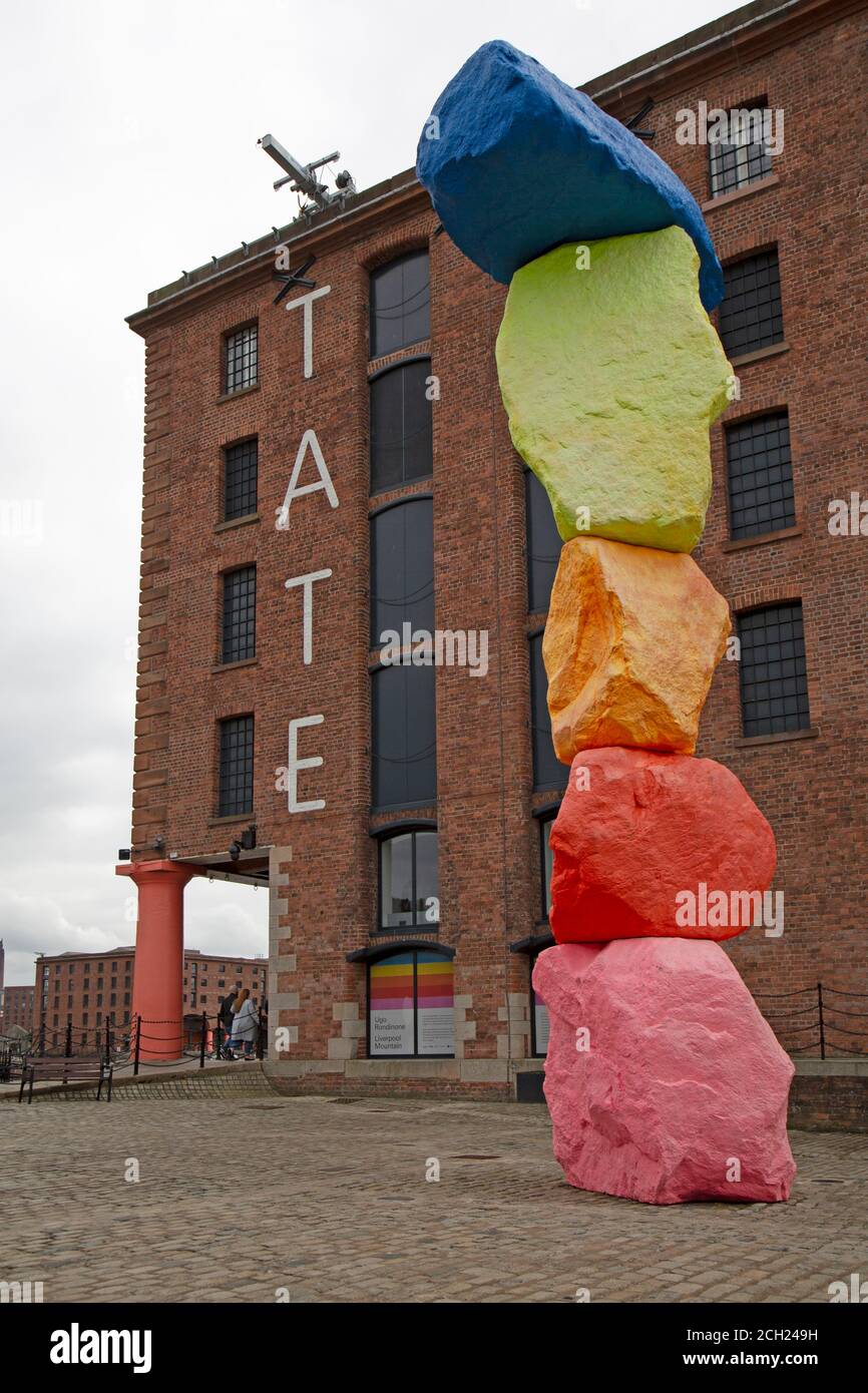The entrance to the Tate Gallery in Liverpool showing a sculpture called 'The Liverpool Mountain' by sculptor and artist Ugo Rondinone. Stock Photo