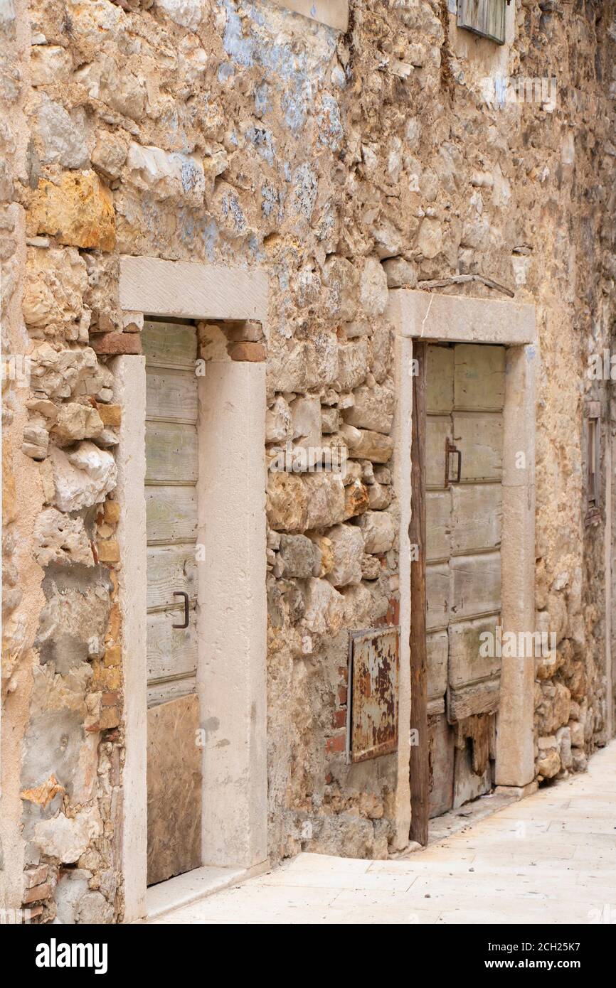 Old abandoned traditional stone house with wooden door shutters in ...