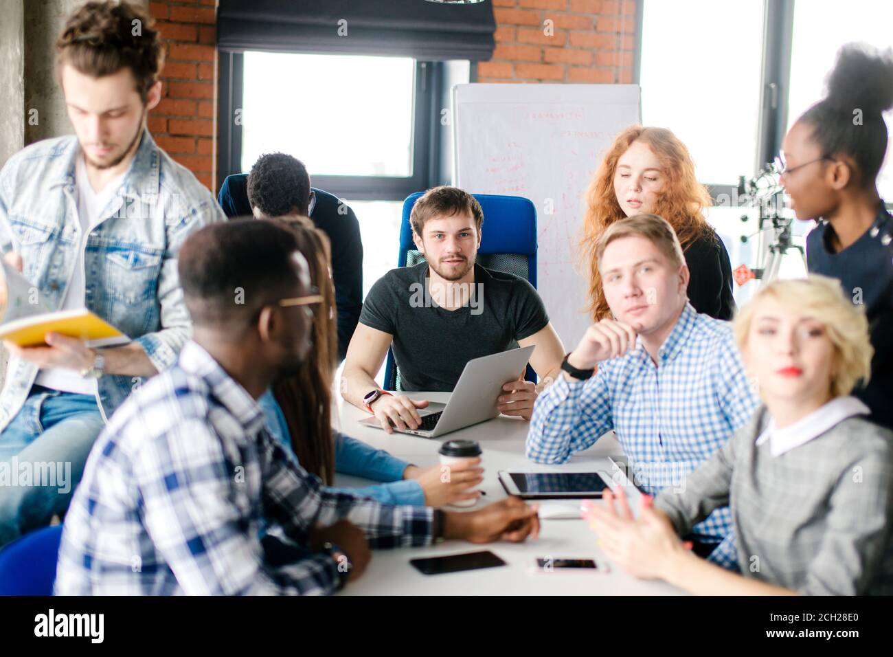 young unexperienced boss cannot force his workers to work. uncontrollable colleagues Stock Photo