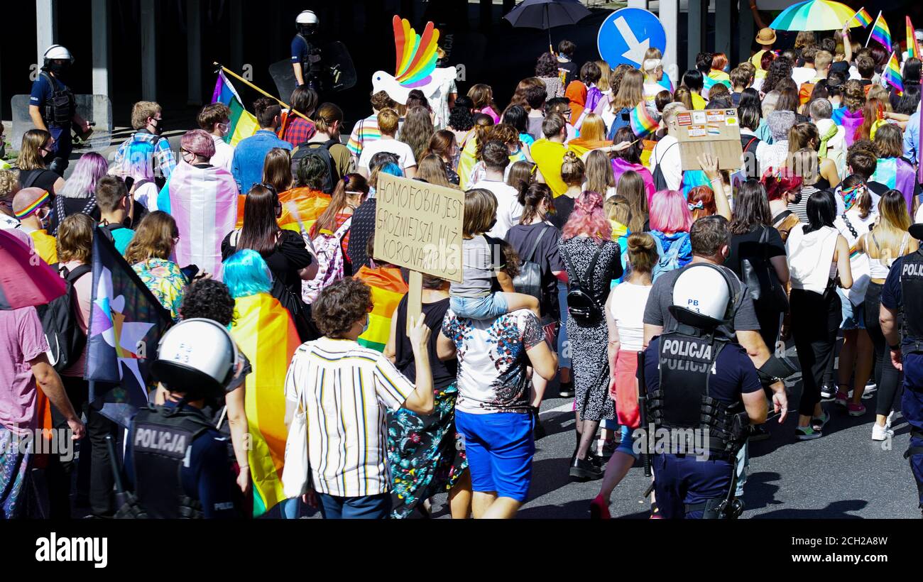 Poland - September 7, 2020: LGBT equality march. Young people wearing rainbows are fighting for LGBTQ+ rights. Police cordon surrounded people Stock Photo