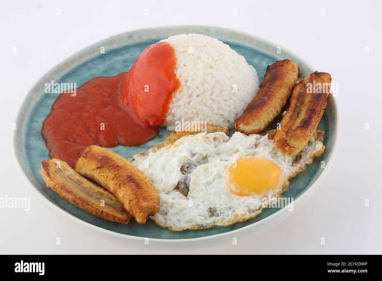 rice with fried eggs tomato sauce and fried banana Stock Photo Alamy