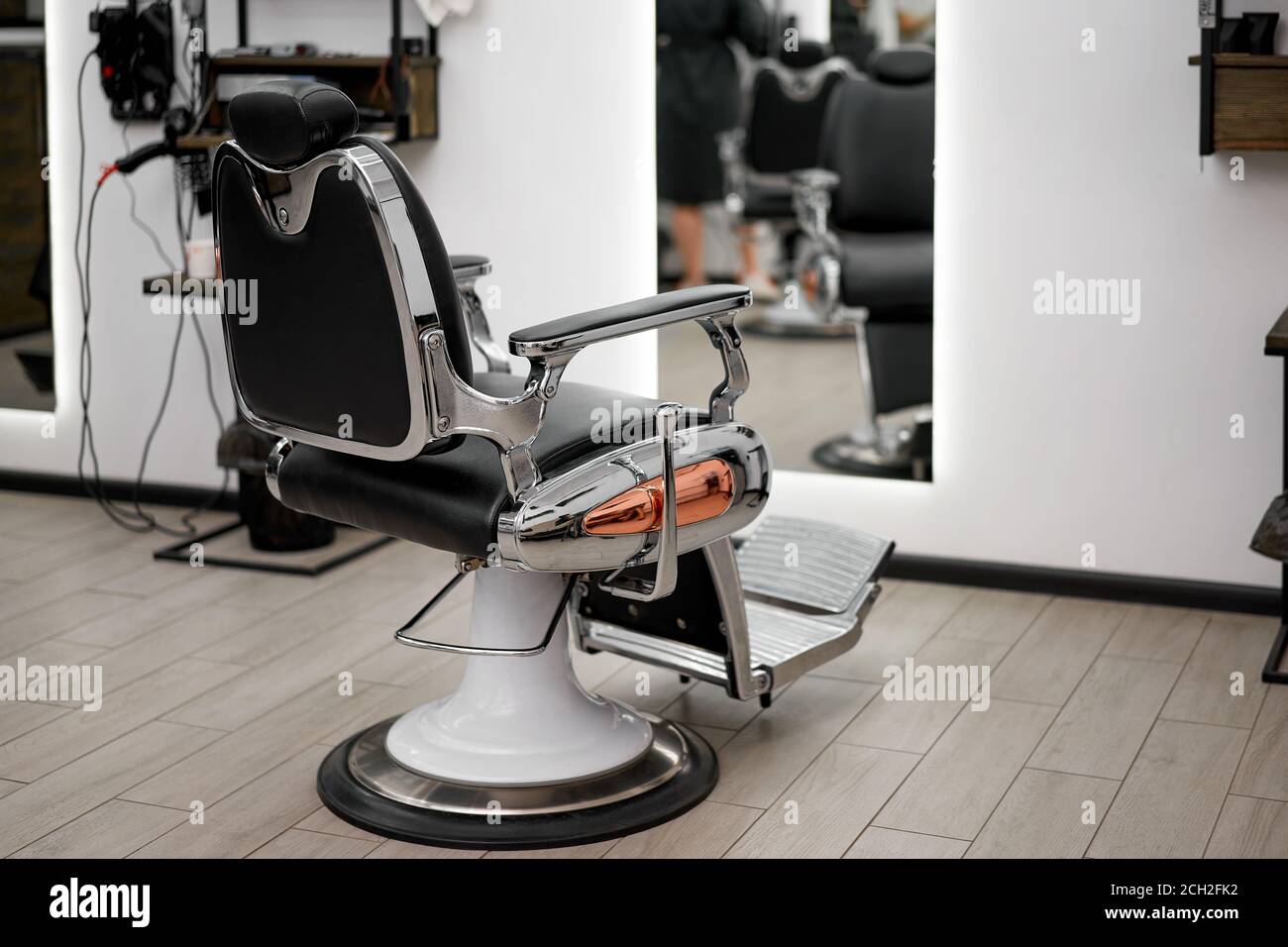 Classic vintage barber chair stands opposite mirror stylish white barber  shop interior Man hairdresser salon Empty retro armchair in barbershop  Profes Stock Photo - Alamy
