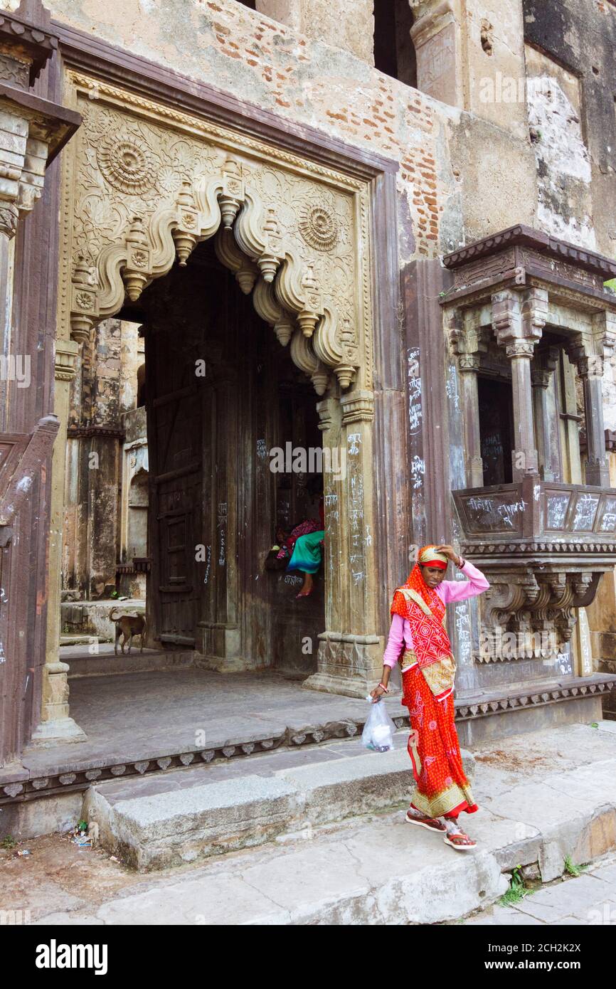 Orchha, Madhya Pradesh, India : A woman walks through the main gate of ...