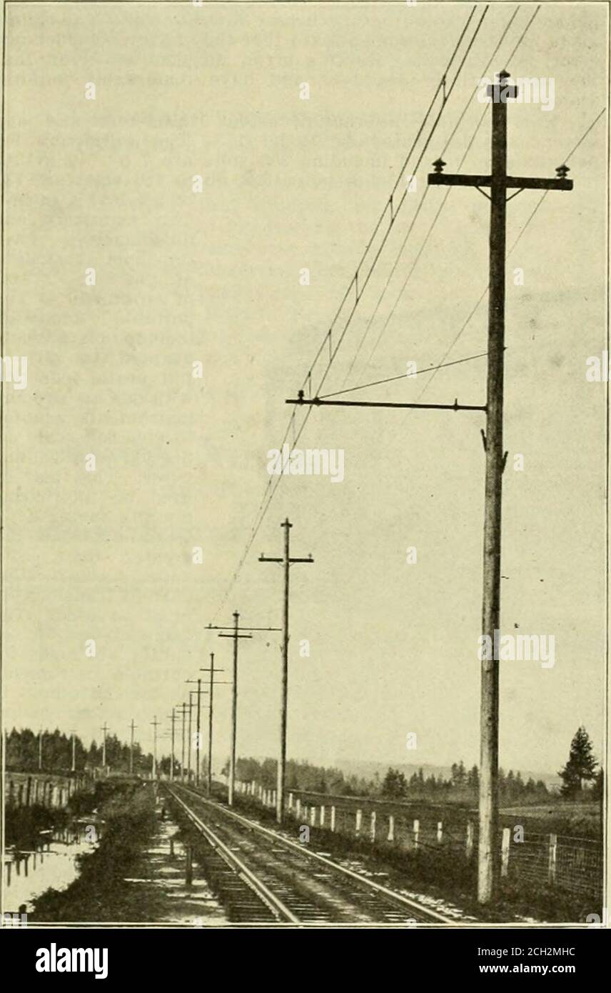 . Electric railway review . arm. A porcelain in- February 22, 190S. ELECTRIC RAILWAY REVIEW 253 sulator for supporting the catenary cable is mounted on amalleable iron pin. which slips over the T-bar. A ,v,-inch high-strength steel messenger cable supportsthe No. 0000 grooved trolley wire, with hangers spaced 10 feetapart. Each hanger consists of a Vk-inch steel bolt, which isscrewed into a 5-inch trolley clip at one end, and into amessenger clip at the other. All the parts are galvanized. For guying on curves a porcelain strain insulator is fast-ened to the pole by two %-inch eyebolts. From t Stock Photo