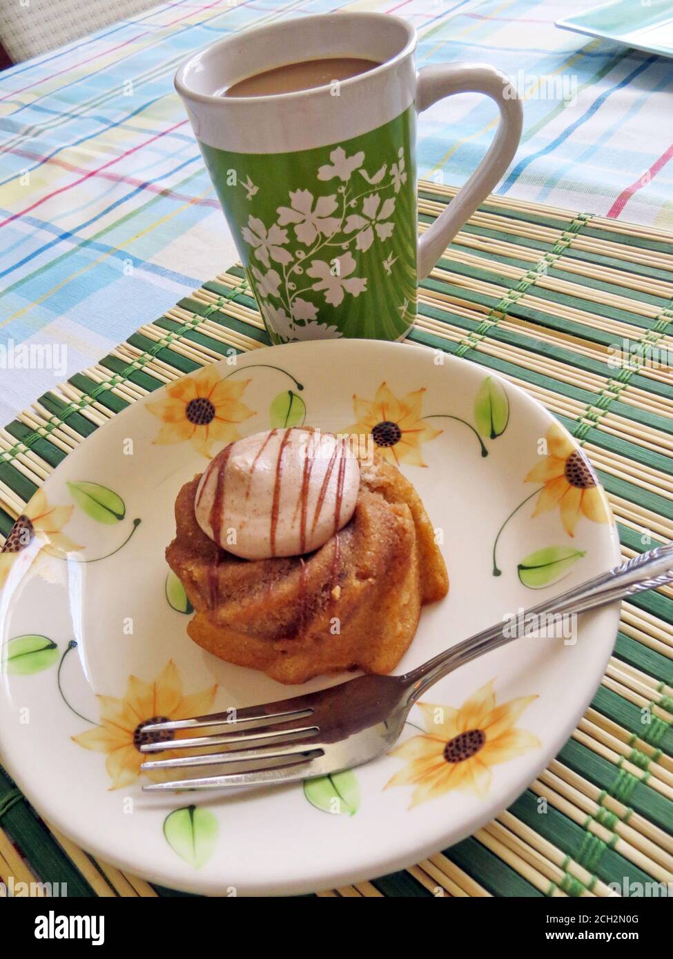 Small cake on a plate with a cup of coffee Stock Photo