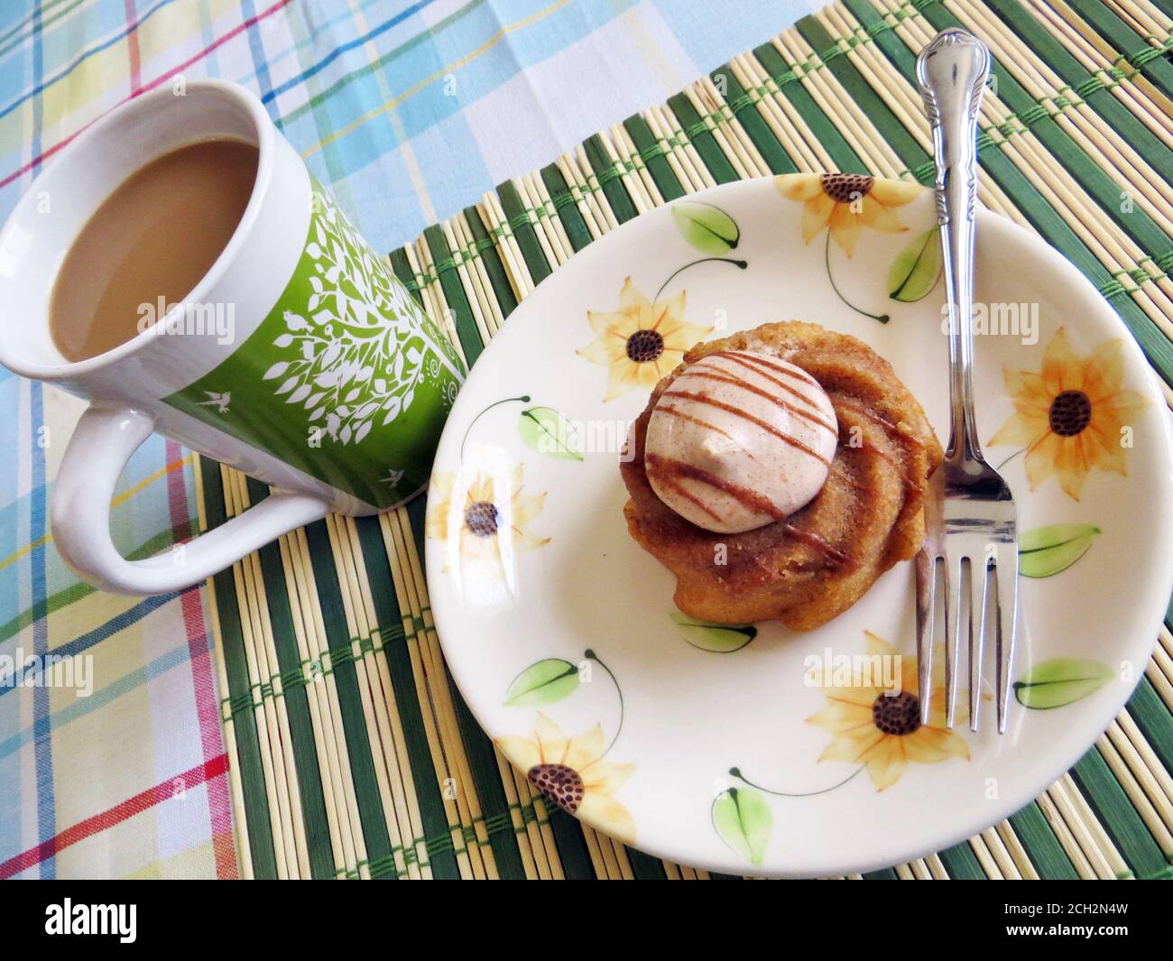 Small cake on a plate with a cup of coffee Stock Photo