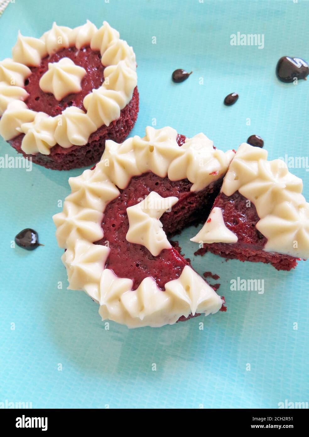 Two small red velvet cakes with white frosting Stock Photo