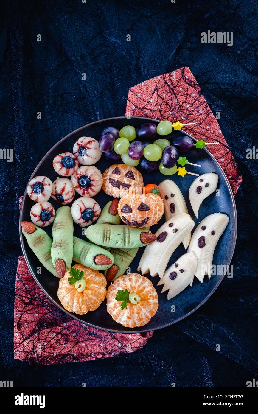 Healthy Fruit Halloween Treats. Banana Ghosts, Clementine Orange Pumpkins and Lychee Eyes Stock Photo