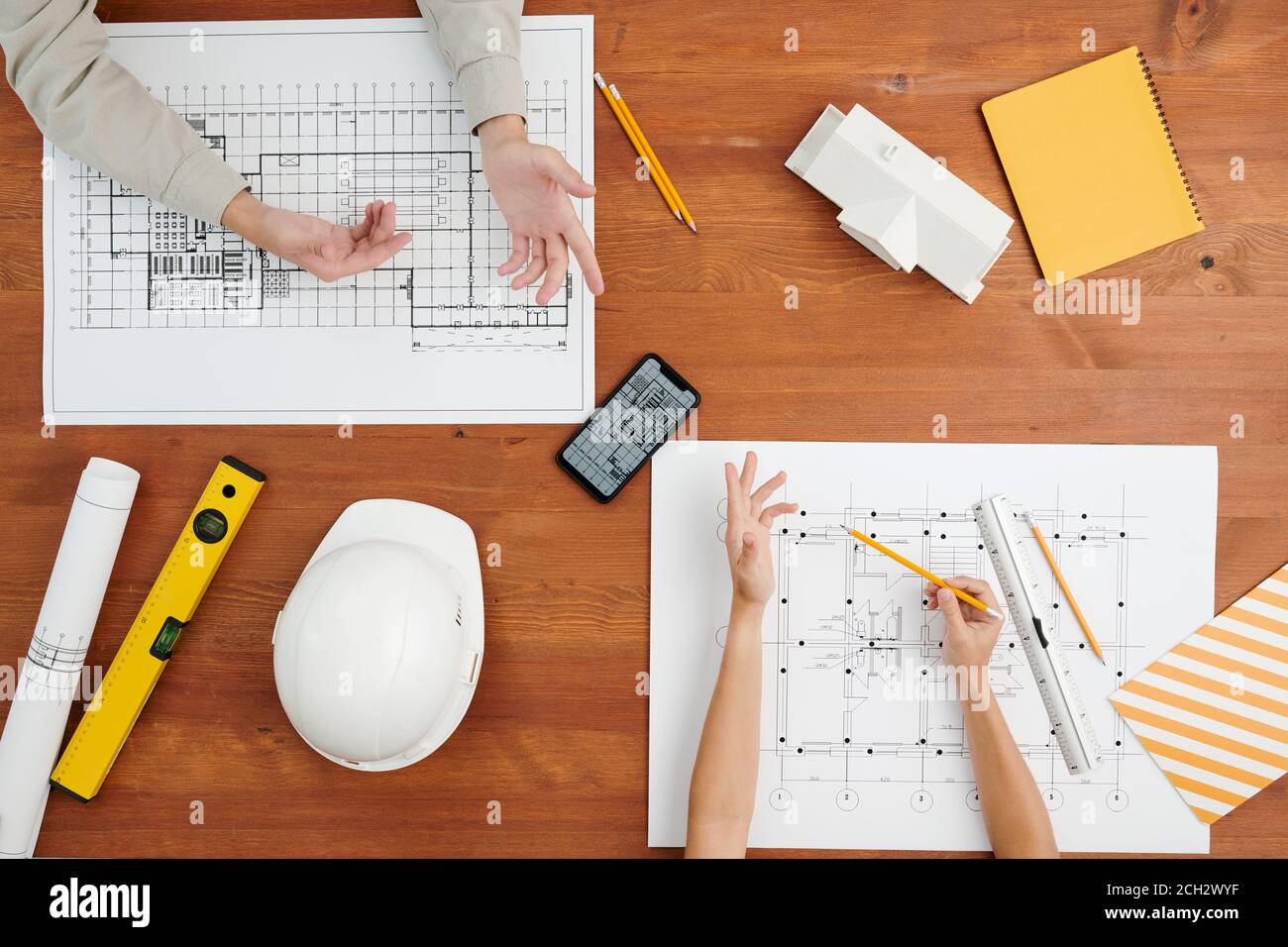 Above view of hands of creative architects during discussion of sketches Stock Photo