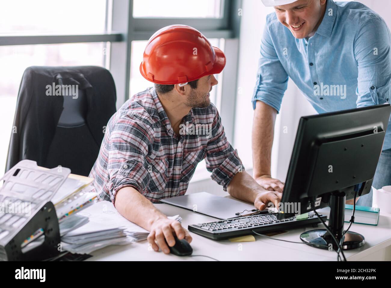 smiling electicians using computer at work. close up portrait Stock Photo