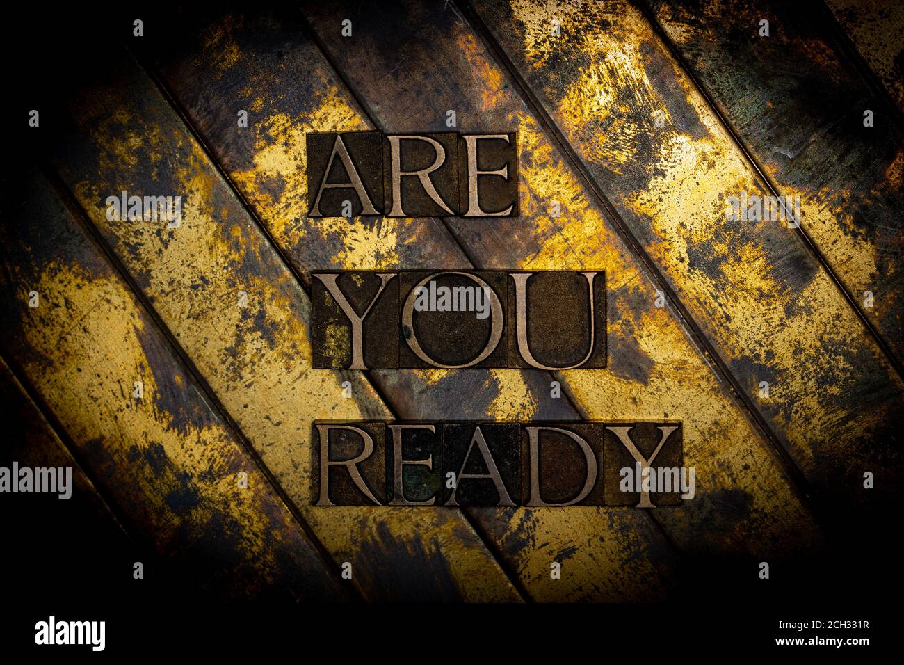 Are You Ready text formed with real authentic typeset letters on vintage textured silver grunge copper and gold background Stock Photo