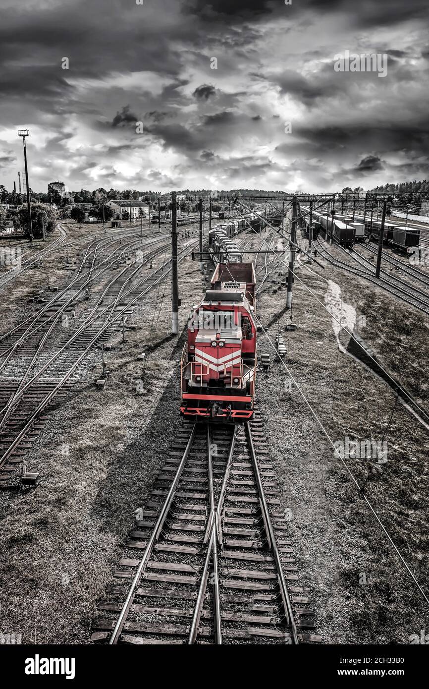 Red train going by railways Stock Photo - Alamy