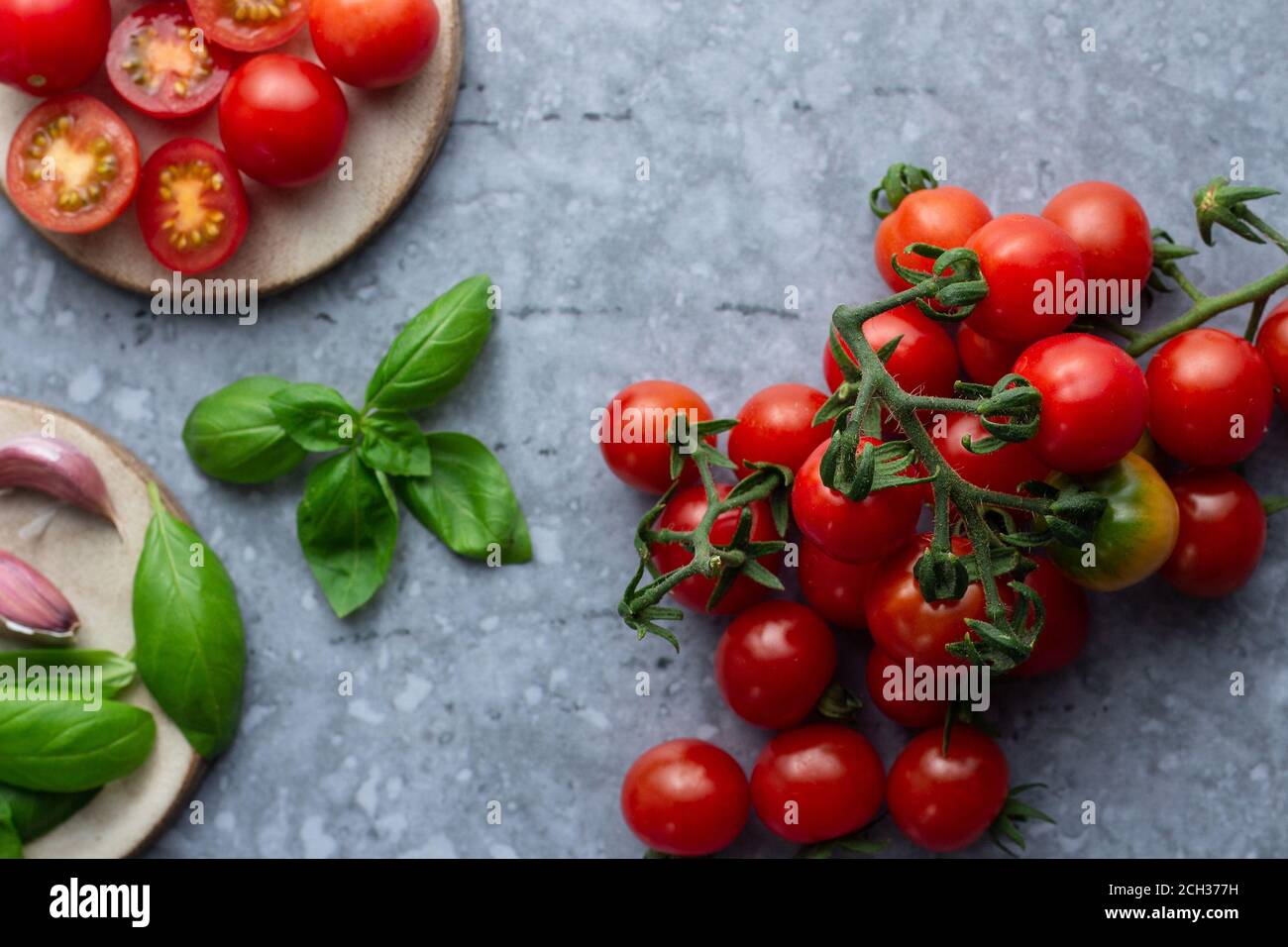 Cherry tomatoes with basil and garlic Stock Photo