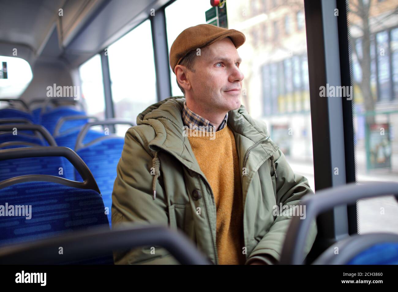 Mature Caucasian man sitting in a public bus Stock Photo