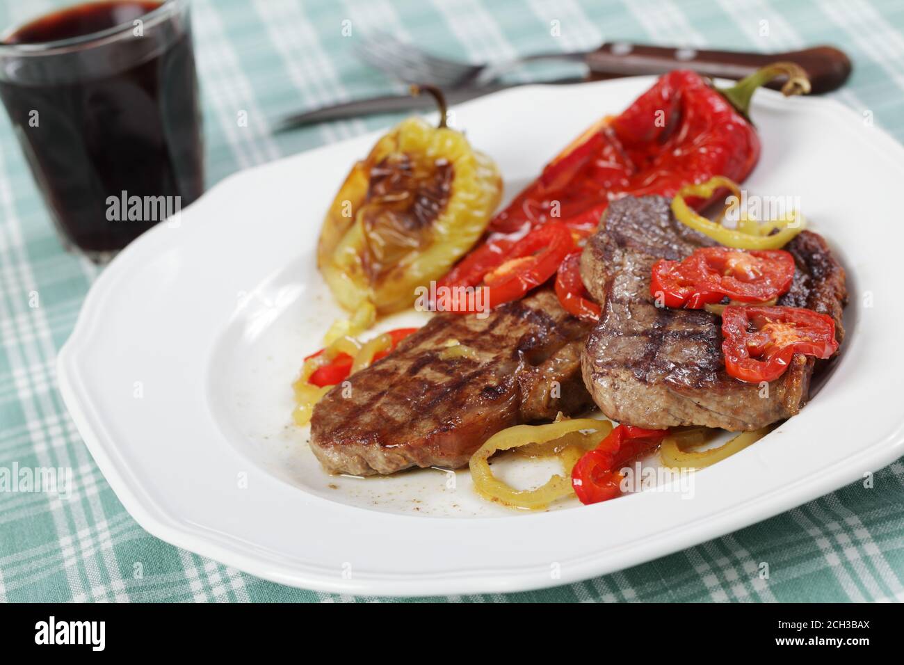 Grilled beef steaks with vegetables and red wine Stock Photo - Alamy