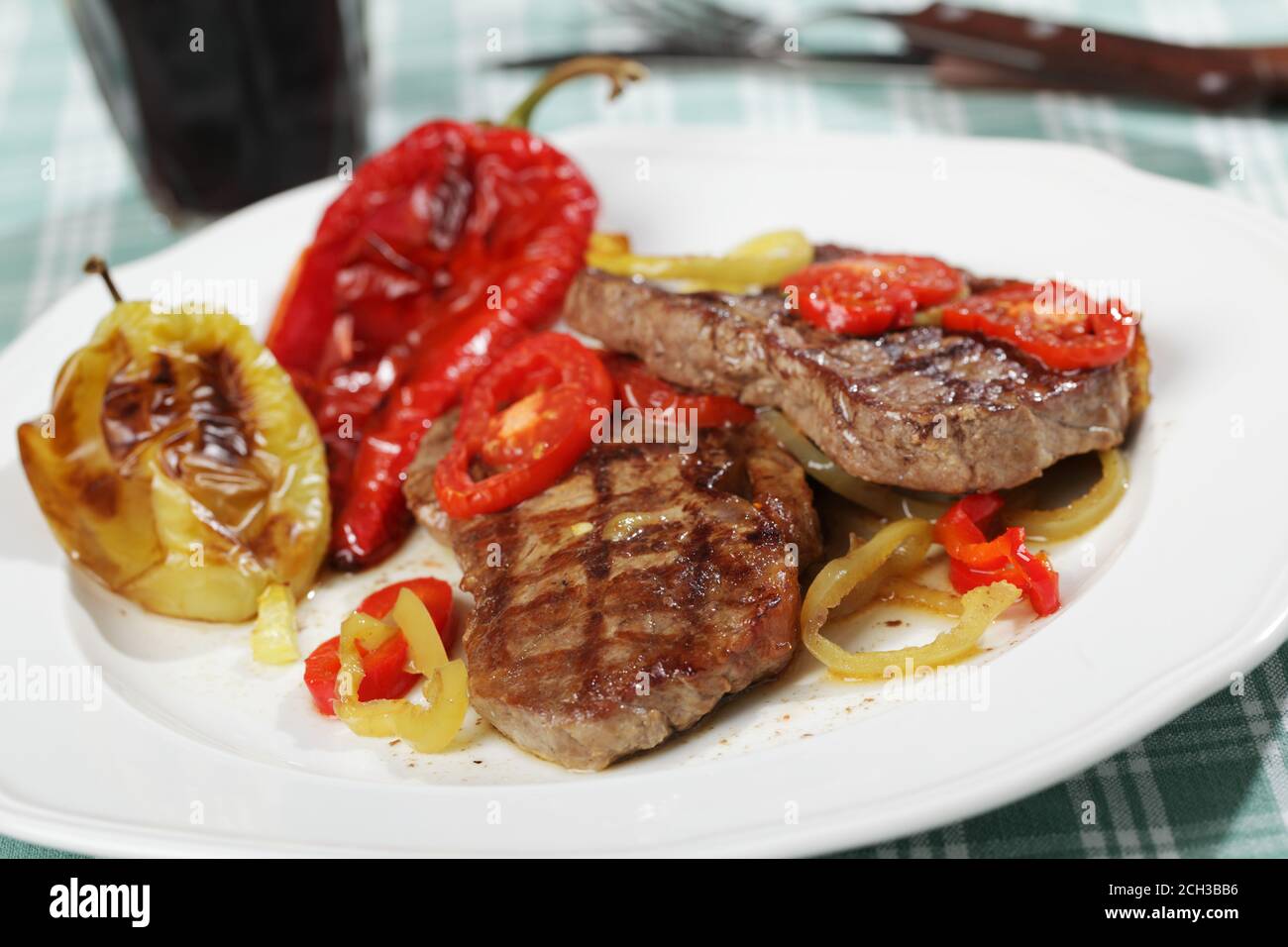 Grilled beef steaks with vegetables and red wine Stock Photo