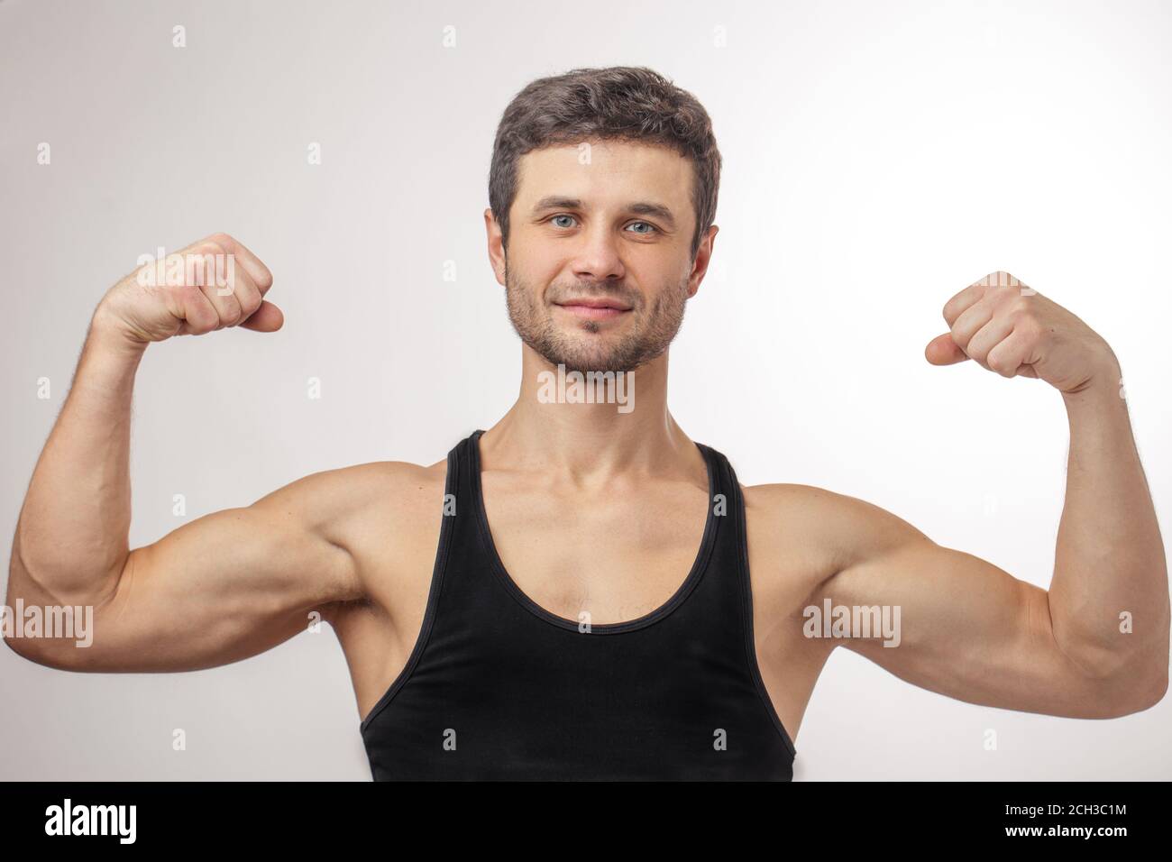 well built guy showing his strong arms Stock Photo Alamy