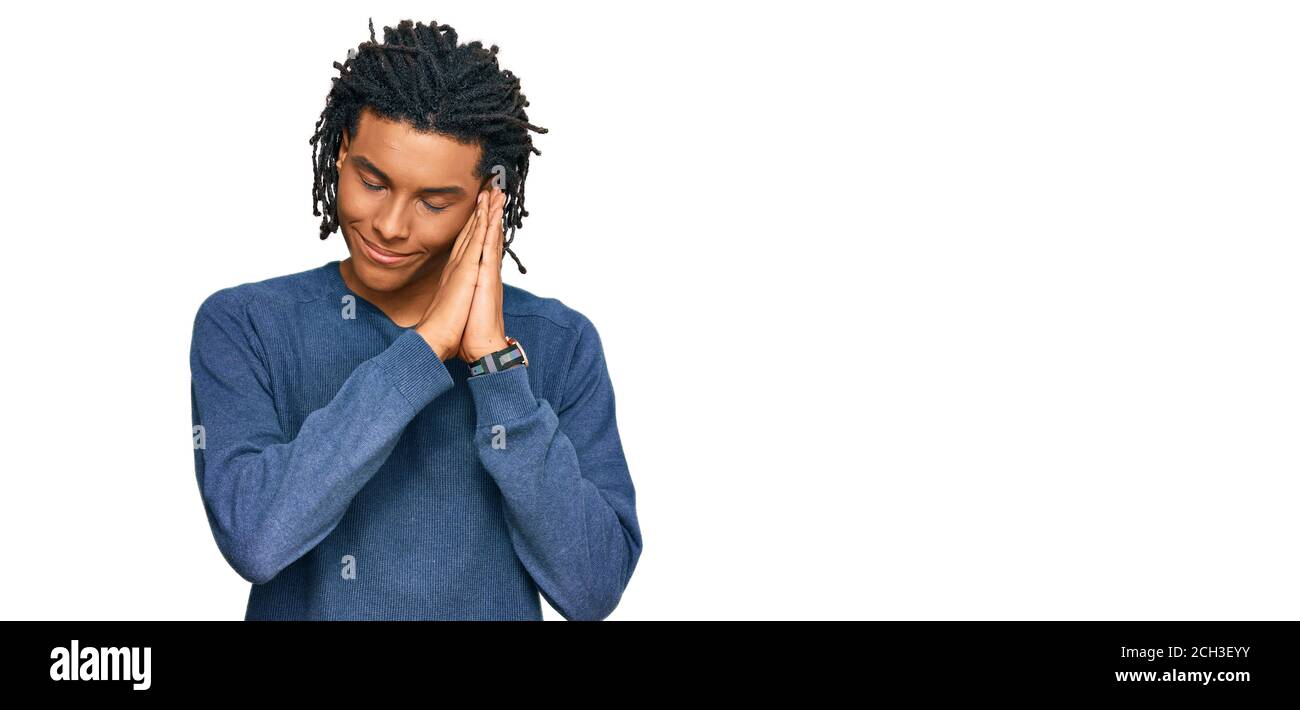 Young african american man wearing casual winter sweater sleeping tired ...