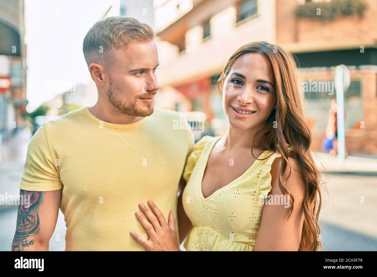 Young couple smiling happy hugging at street of city Stock Photo - Alamy