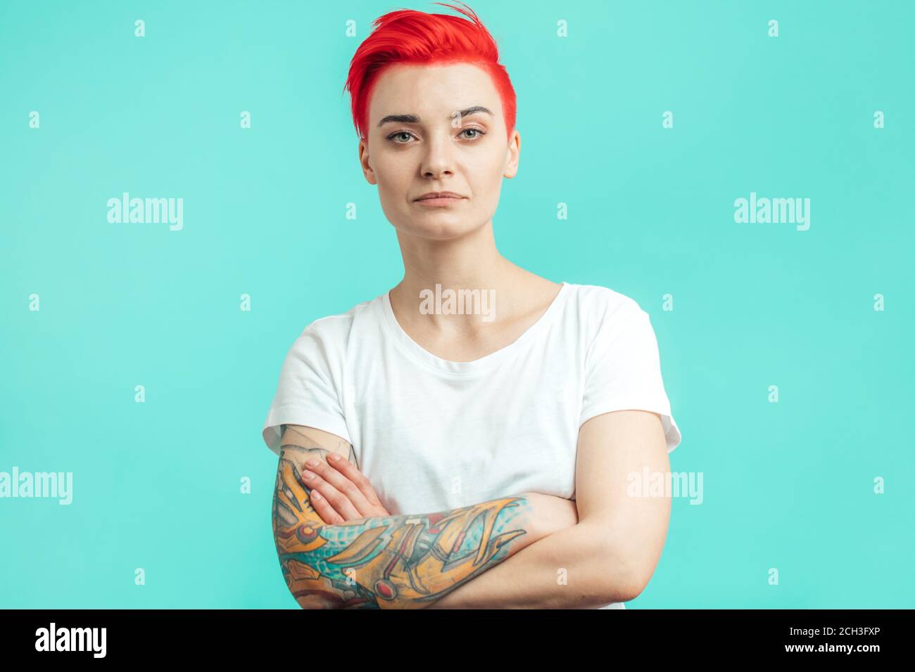 serious emo girl isolated over blue wall background with arms crossed. Looking at the camera. Stock Photo