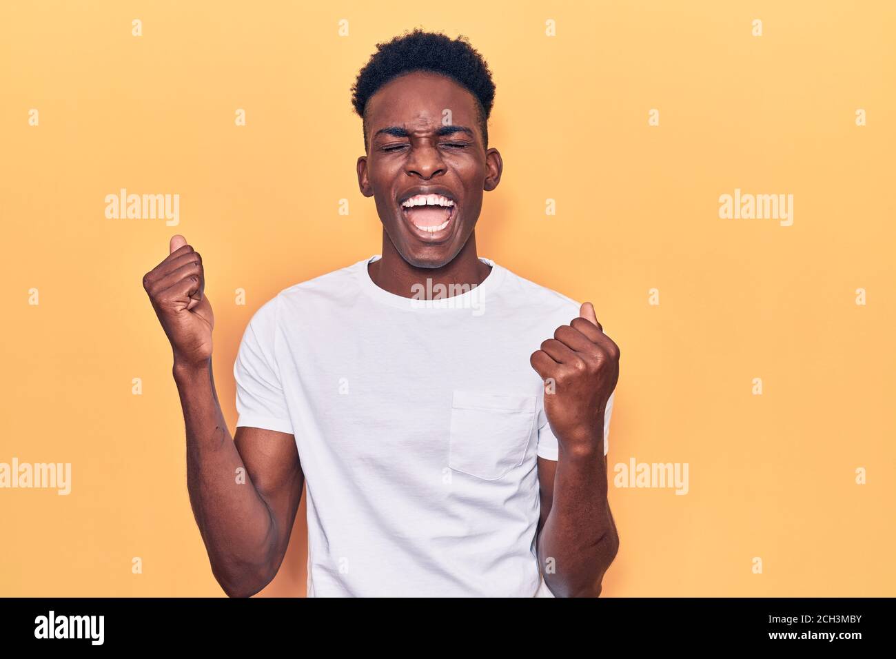 Young african american man wearing casual clothes celebrating surprised ...