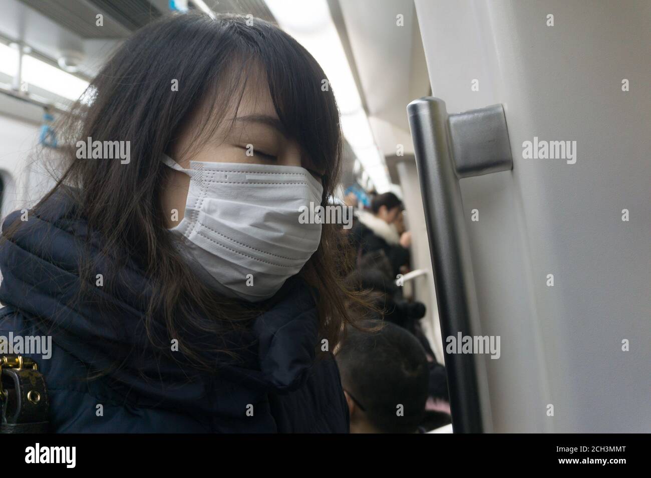 Japanese young woman wearing a hygiene protective mask over her face on