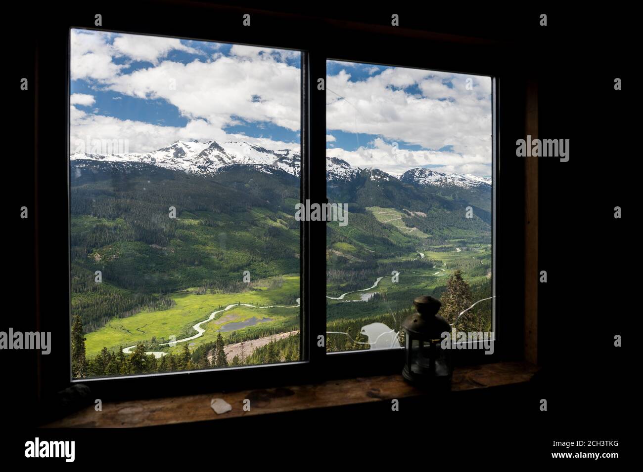 Mountains and green valley behind window Stock Photo - Alamy