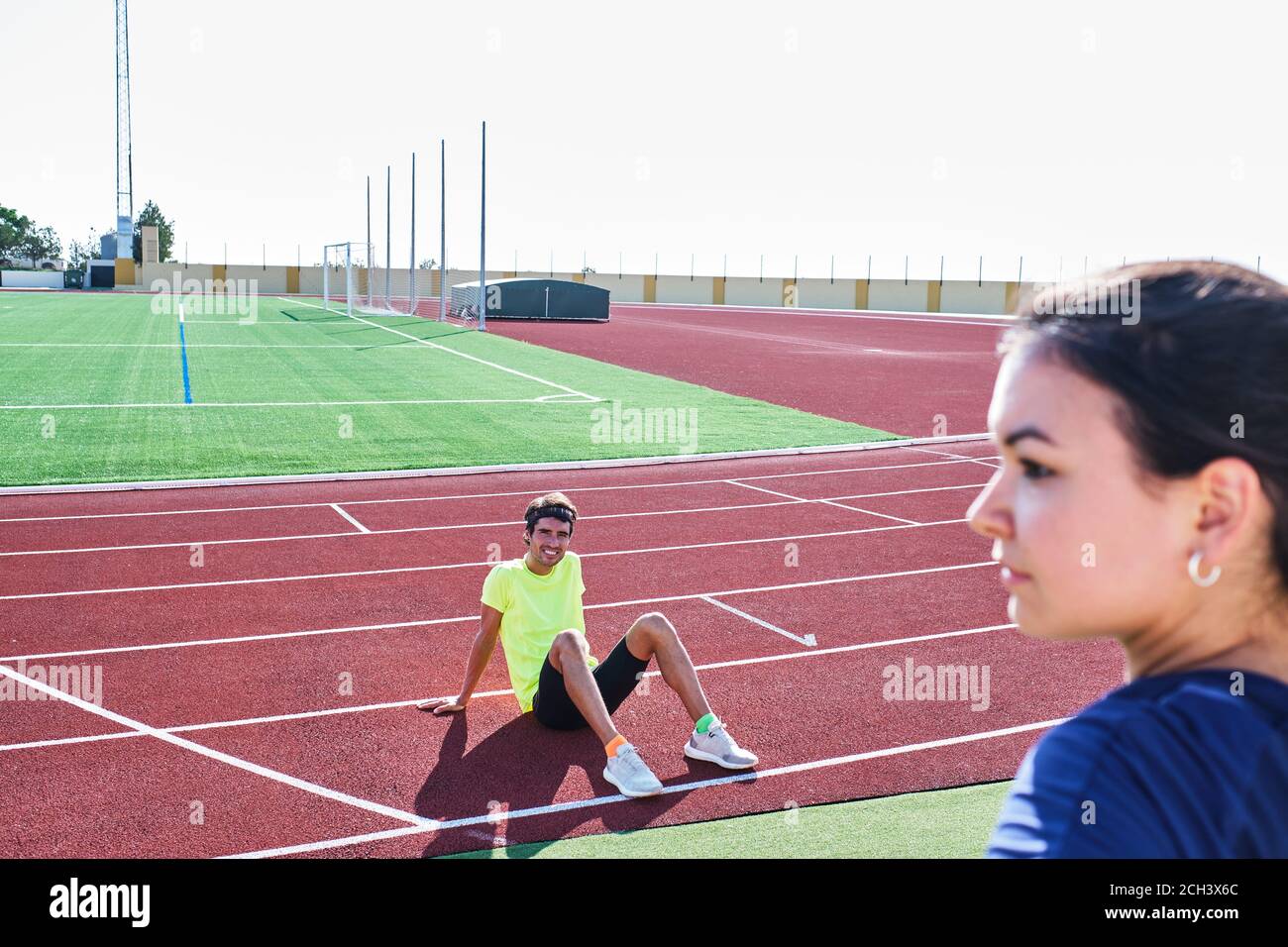 young coach smiles at one of his students as she looks out over the ho