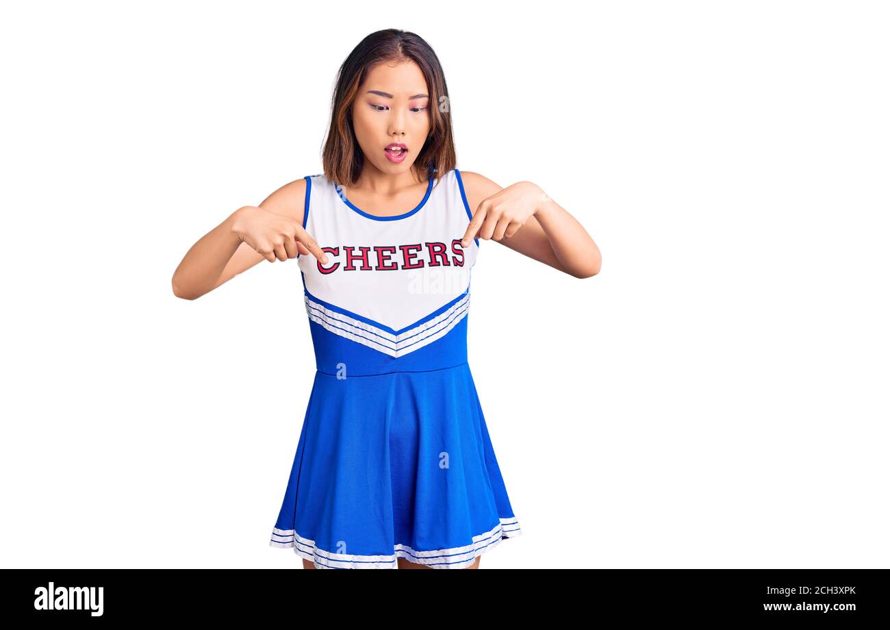 Young Beautiful Chinese Girl Wearing Cheerleader Uniform Pointing Down