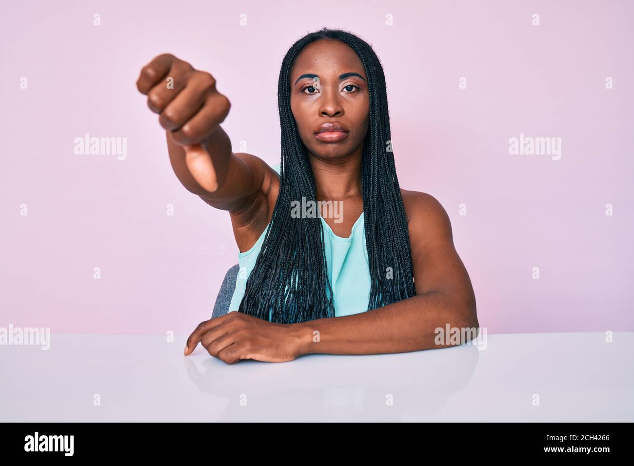 African american woman with braids wearing casual clothes sitting on ...