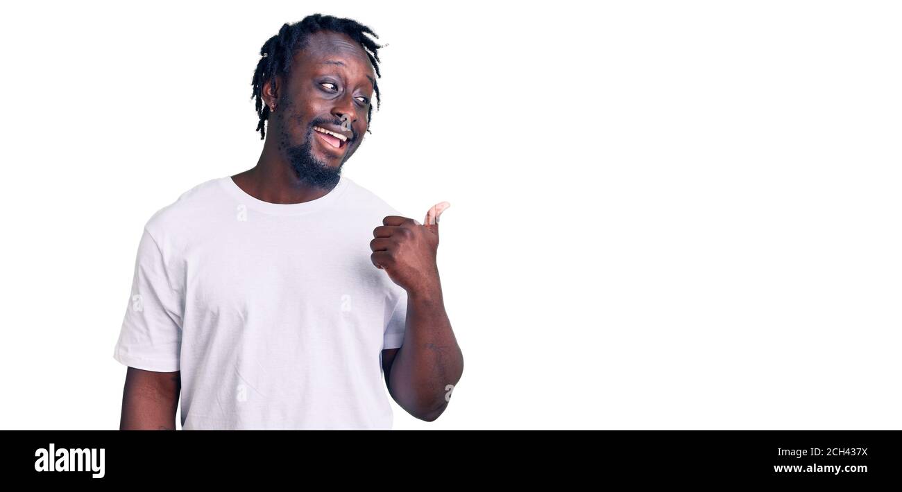 Young african american man with braids wearing casual white tshirt ...