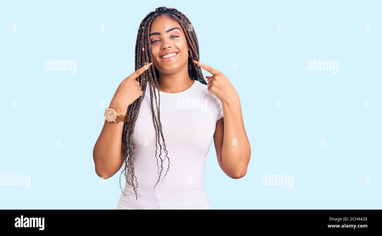 Young african american woman with braids wearing casual clothes smiling ...