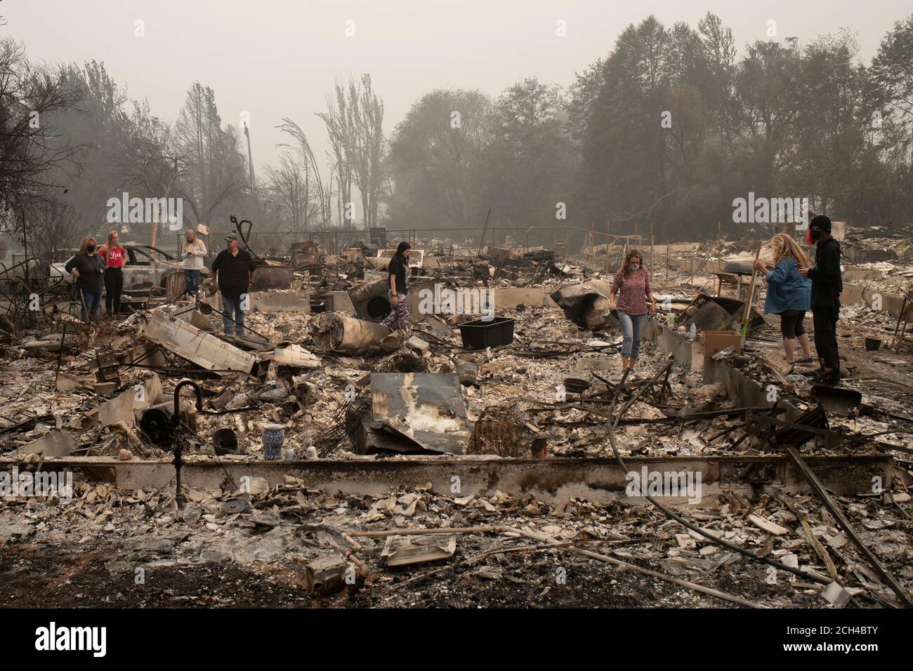 The Webber family searches for belongings through their home, which was gutted by the Almeda fire, in Talent, Oregon, U.S., September 13, 2020.  REUTERS/Adrees Latif Stock Photo