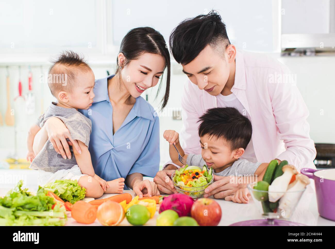 happy family preparing dinner with healthy  food in kitchen Stock Photo