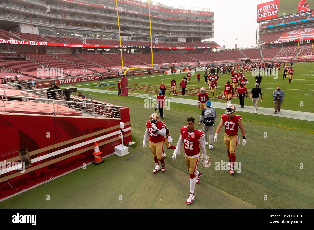 Santa Clara, CA, USA. 13th Sep, 2020. San Francisco 49ers player walk off  the field in an empty stadium after a 24-20n loss to the Arizona Cardinals  during the season opening NFL