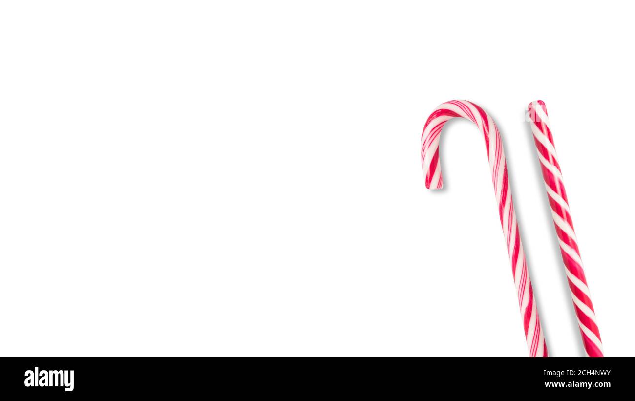 Close up photo of a red and white candy cane on a white background