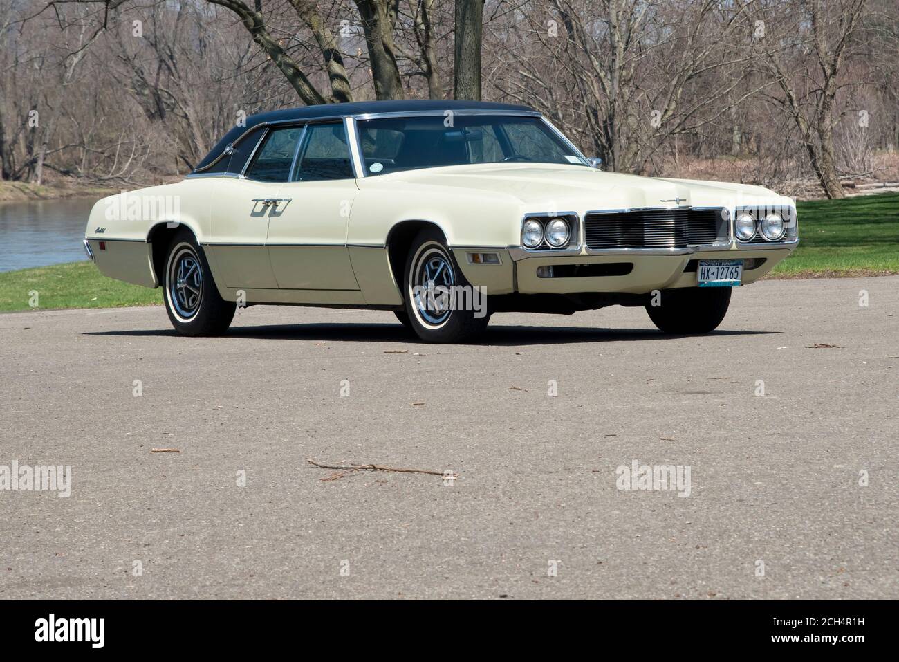 1970 Thunderbird Landau sedan front three-quarter view in park along river Stock Photo