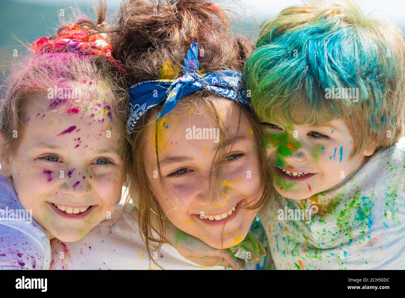 Painted kids face on colorful background holi, closeup. Festival of colors.  Children draws paints Stock Photo - Alamy