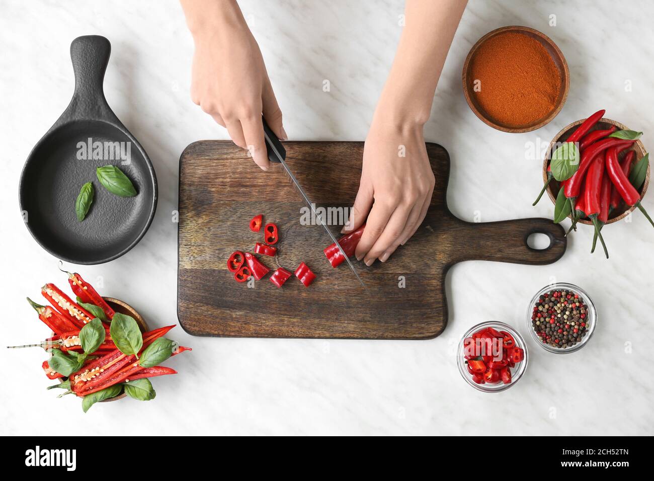 Woman cutting hot chili pepper, top view Stock Photo - Alamy