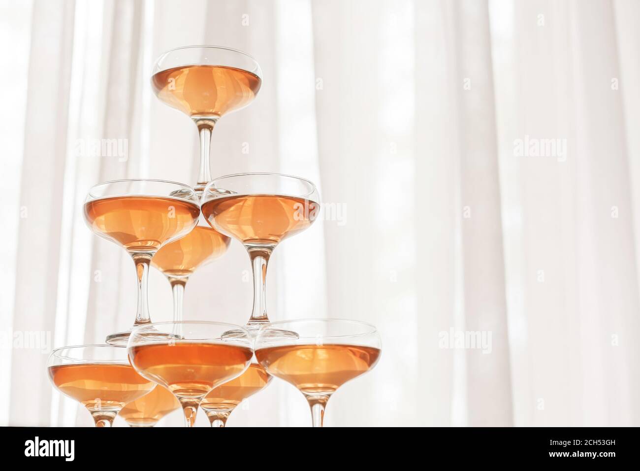 Tower made of glasses with champagne indoors Stock Photo Alamy