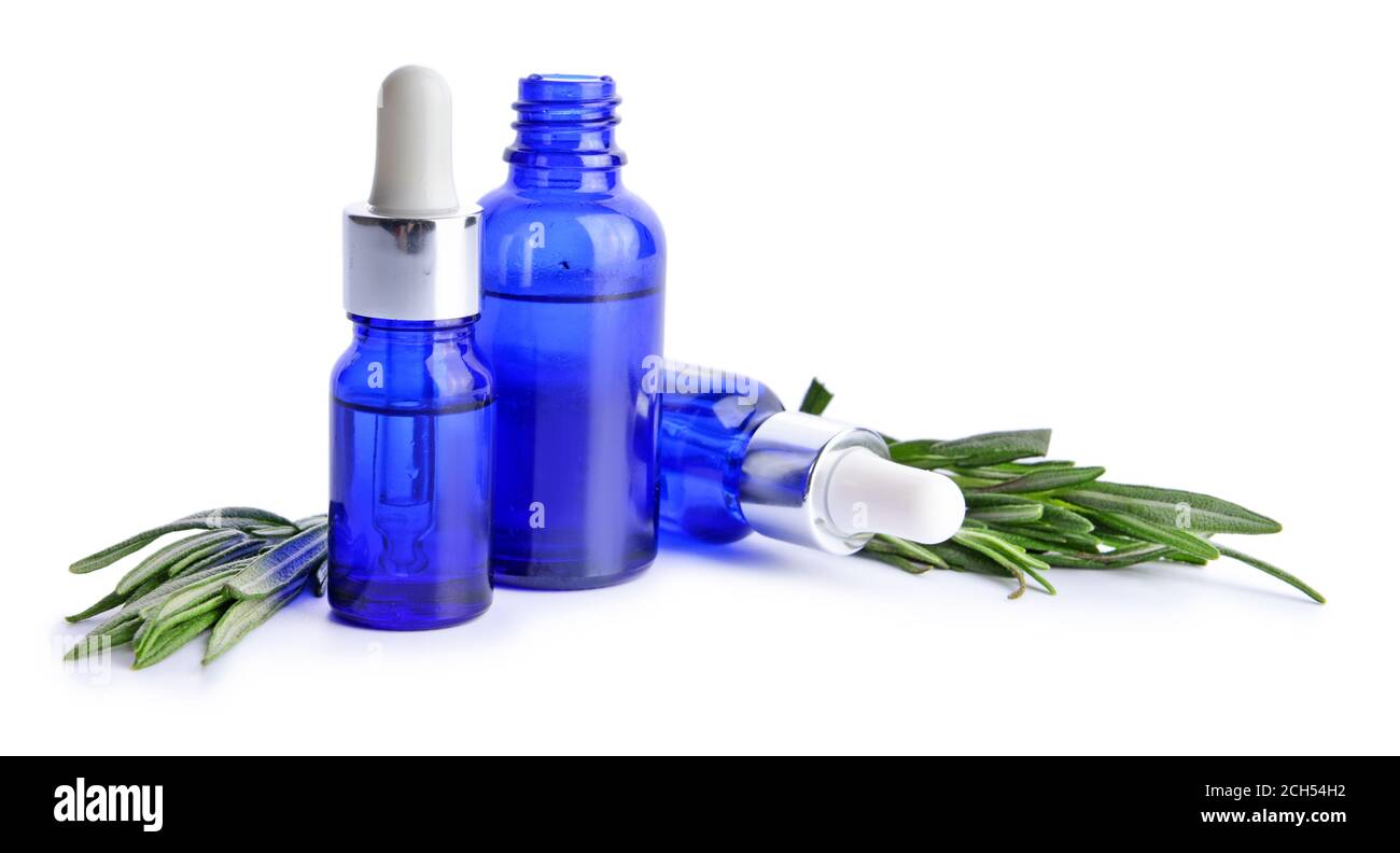 Bottles of rosemary essential oil on white background Stock Photo - Alamy
