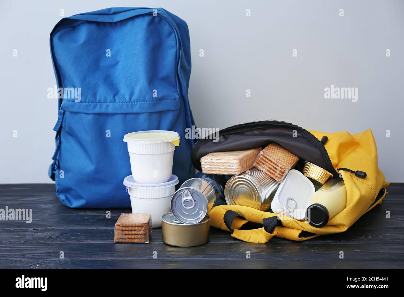 Schoolbag with different products on table. Concept of Backpack Food ...